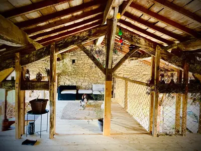 an old building with a dog in a room at La Main du Cœur Chambre d'hôtes de charme à la campagne in Loubens-Lauragais