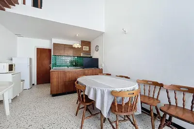 a kitchen with a table and chairs in a room at Bright Family Home Near the Sea in Port-la-Nouvelle