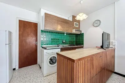 a kitchen with a sink and a washing machine at Bright Family Home Near the Sea in Port-la-Nouvelle