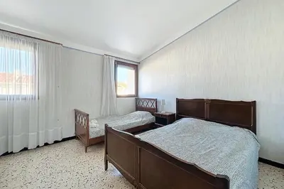 a bedroom with two beds and a window at Bright Family Home Near the Sea in Port-la-Nouvelle