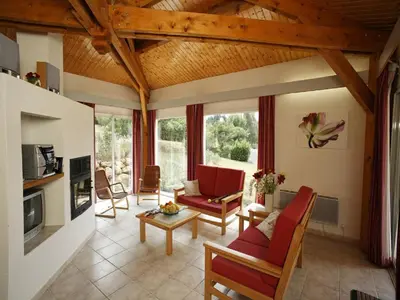 a living room with red chairs and a couch at Cozy Family Getaway Home in Quillan
