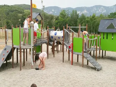 a group of children playing on a playground at Cozy Family Getaway Home in Quillan