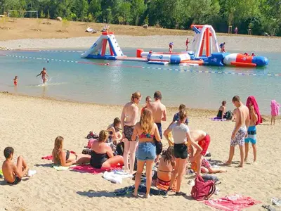 a group of people on a beach with a water park at Cozy Family Getaway Home in Quillan