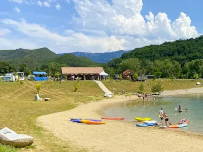 a group of people on a beach with boats in the water at Cozy Family Getaway Home in Quillan