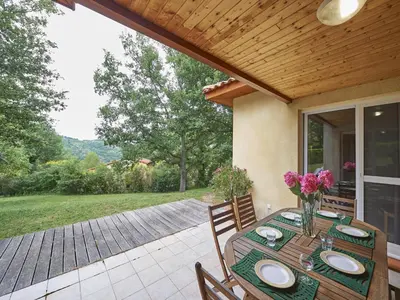 a table with plates on it on a patio at Cozy Family Getaway Home in Quillan