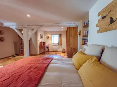 a living room with a couch and a table at Le COULOUMIER côté lac in Caignac