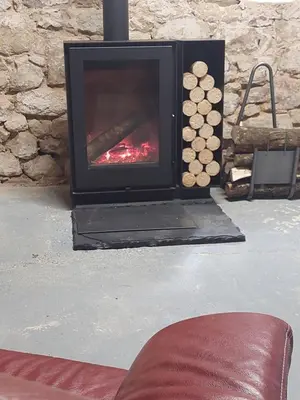 a fireplace sitting in a living room with a fire place at Horizon des Corbières in Saint-André-de-Roquelongue