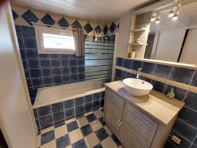 a bathroom with blue tiles and a sink and a tub at Horizon des Corbières in Saint-André-de-Roquelongue