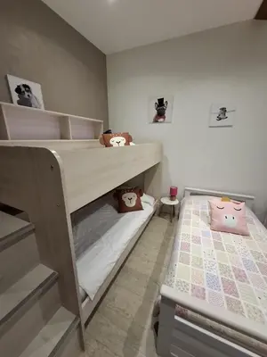 a bedroom with a bed with a sign on the wall at Horizon des Corbières in Saint-André-de-Roquelongue