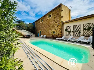a swimming pool in front of a building at Horizon des Corbières in Saint-André-de-Roquelongue