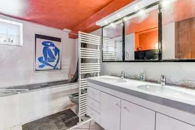 a bathroom with two sinks and a toilet in it at Maison de famille Lafonsèque in Renneville