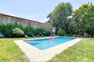 a swimming pool with a pink toy in a yard at Maison de famille Lafonsèque in Renneville