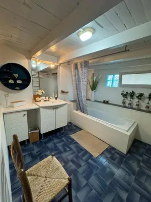 a large bathroom with a tub and a sink at La maison Auguste - vue imprenable sur la Cité in Carcassonne