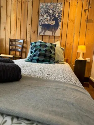 a bedroom with a bed with a pillow and a chair at La maison Auguste - vue imprenable sur la Cité in Carcassonne