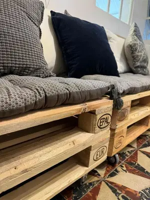 a bed on a wooden platform with pillows on it at La maison Auguste - vue imprenable sur la Cité in Carcassonne