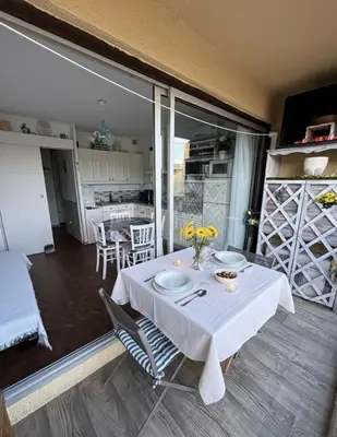 a dining room table with a white tablecloth on it at Fleur Australe in Gruissan