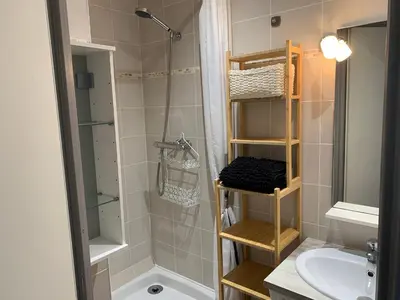 a bathroom with a shower and a toilet and a sink at Fleur Australe in Gruissan