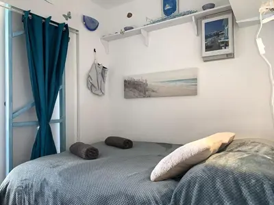 a bedroom with a bed with two pillows on it at Fleur Australe in Gruissan