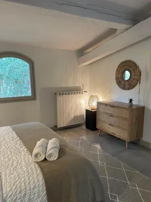 a bedroom with a bed with two towels on it at La Tuilerie du Bazalac in Trèbes