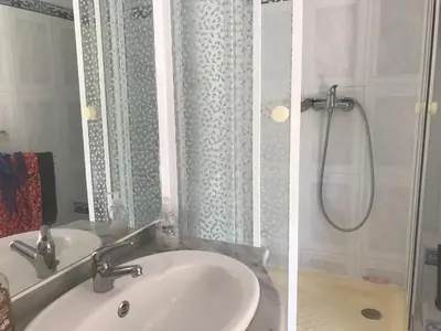 a bathroom with a sink and a shower at Chez Martine Côté Cité in Carcassonne