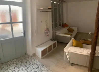 a living room with two white couches and a window at Cocon mazerien in Mazères