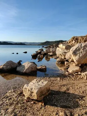 a group of rocks on the shore of a body of water at T2 cabine relooké avec piscine idéalement situé in Gruissan