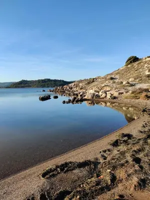 a body of water with rocks on the shore at T2 cabine relooké avec piscine idéalement situé in Gruissan