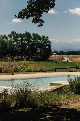 a swimming pool in a garden with trees in the background at Zero Neuf in Gaudiès