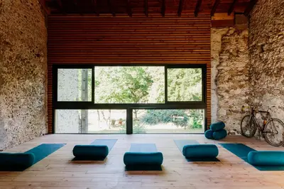 a room with blue chairs and a large window at Zero Neuf in Gaudiès