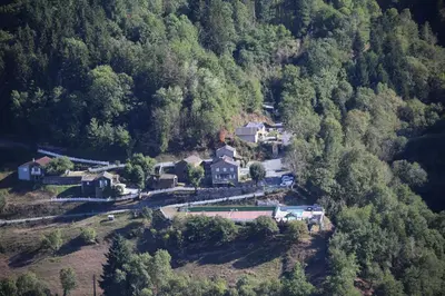 an aerial view of a house in a forest at L'oustal in Lacrouzette