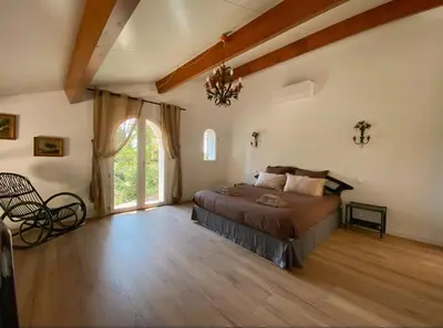 a bedroom with a bed and a large window at Architect's house Cleopatra luxury , private pool in heart of nature for 2 people in Quarante