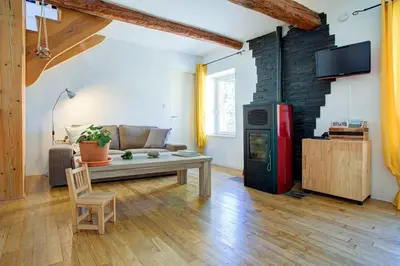a living room with a couch and a red refrigerator at L'Oustalet - Single-family home with terrace Oustalet in Ferrals-lès-Corbières