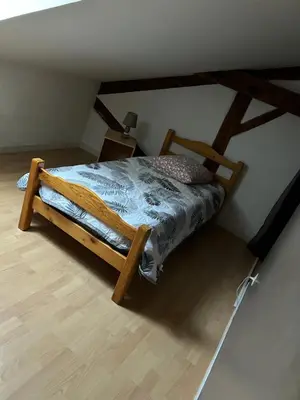 a bedroom with a wooden bed in a room at Vistetta in Narbonne