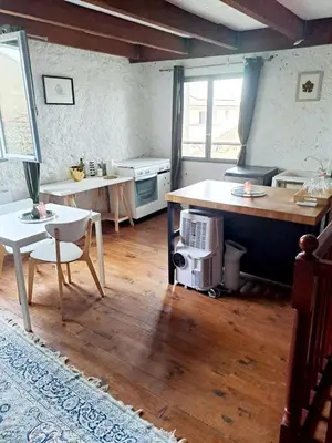 a kitchen with a table and a counter top at Le logis des vendangeurs in Puisserguier