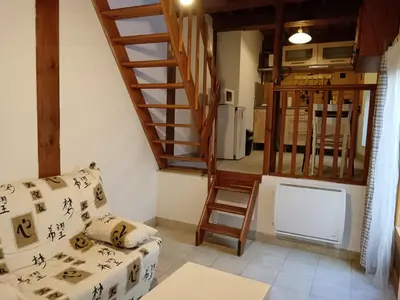 a living room with a staircase and a couch at apt7 in Castelnaudary