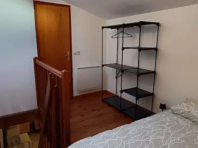 a bedroom with a book shelf next to a bed at apt7 in Castelnaudary