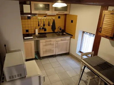 a small kitchen with a sink and a table at apt7 in Castelnaudary