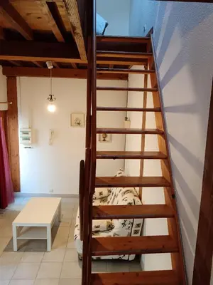 a bunk bed in a room with a ladder at apt7 in Castelnaudary