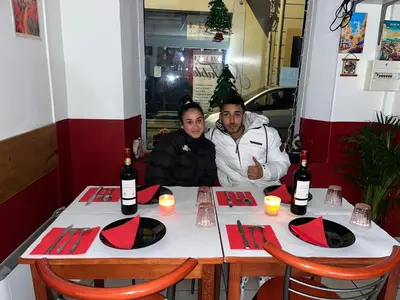 two people sitting at a table with wine bottles at Hernesto in Carcassonne