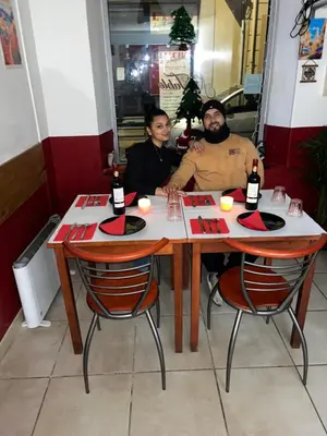 a group of people sitting at a table in a restaurant at Hernesto in Carcassonne