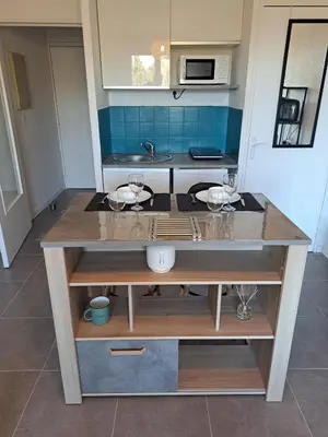 a kitchen with a counter with glasses on it at studio proche Narbonne centre in Narbonne