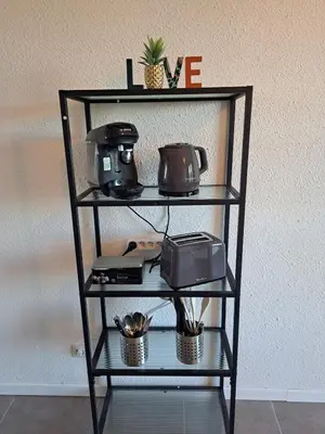 a shelf with a toaster and a radio on it at studio proche Narbonne centre in Narbonne
