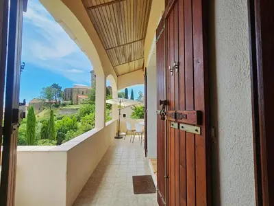 an open door to a balcony with a view at Sourire du Soleil in Montouliers
