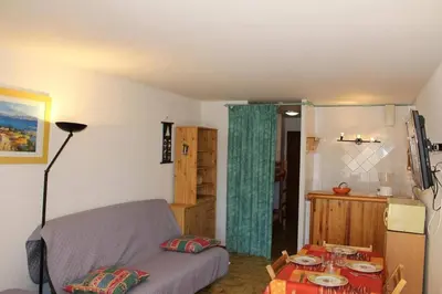 a living room with a couch and a table at Appartement Studio Cabine - Gruissan GN110-C13 in Gruissan