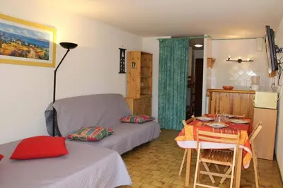a living room with a couch and a table at Appartement Studio Cabine - Gruissan GN110-C13 in Gruissan
