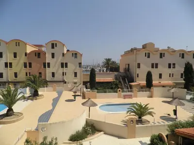 a resort with a swimming pool and some buildings at Appartement 2 pièces cabine - Gruissan GN130-820 in Gruissan