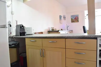 a kitchen with wooden cabinets and a counter top at Appartement évasion sur le port de Gruissan - GN380-C67 in Gruissan