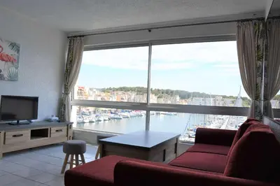 a living room with a view of a large window at Appartement évasion sur le port de Gruissan - GN380-C67 in Gruissan