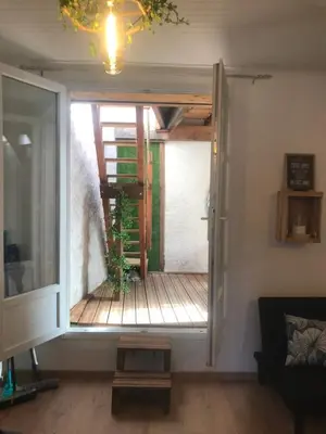 a living room with a door open to a deck at Cœur d 'amande in Narbonne