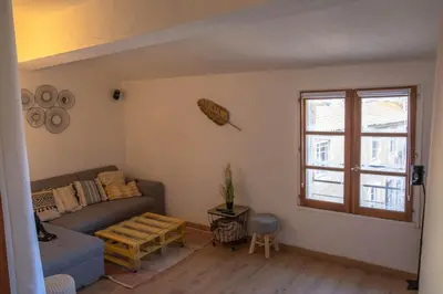 a living room with a couch and a window at Cœur d 'amande in Narbonne